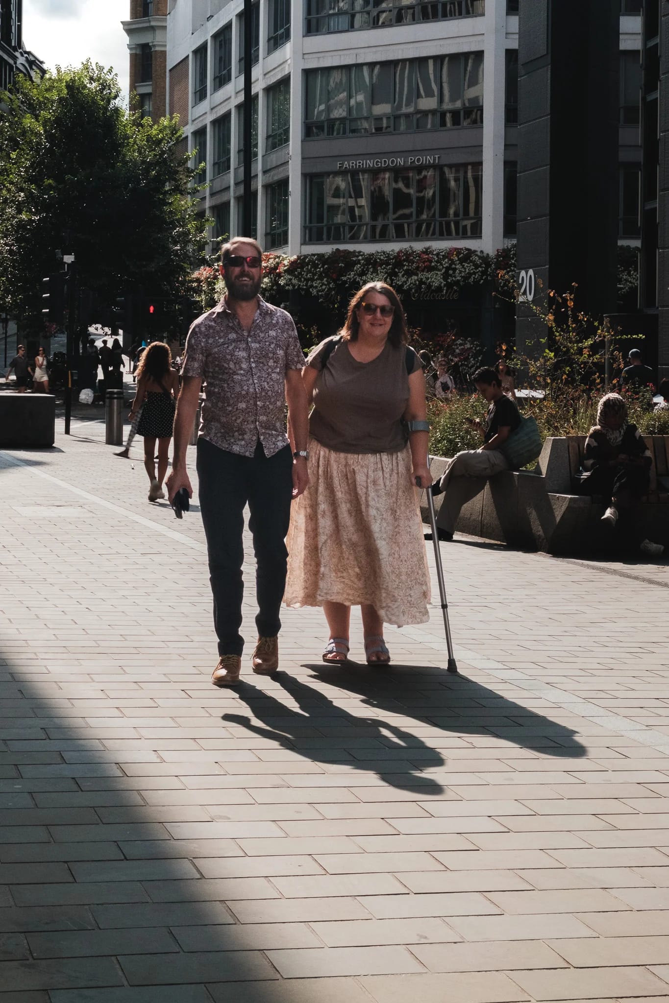 Couple Strolling on a Sunny City Street