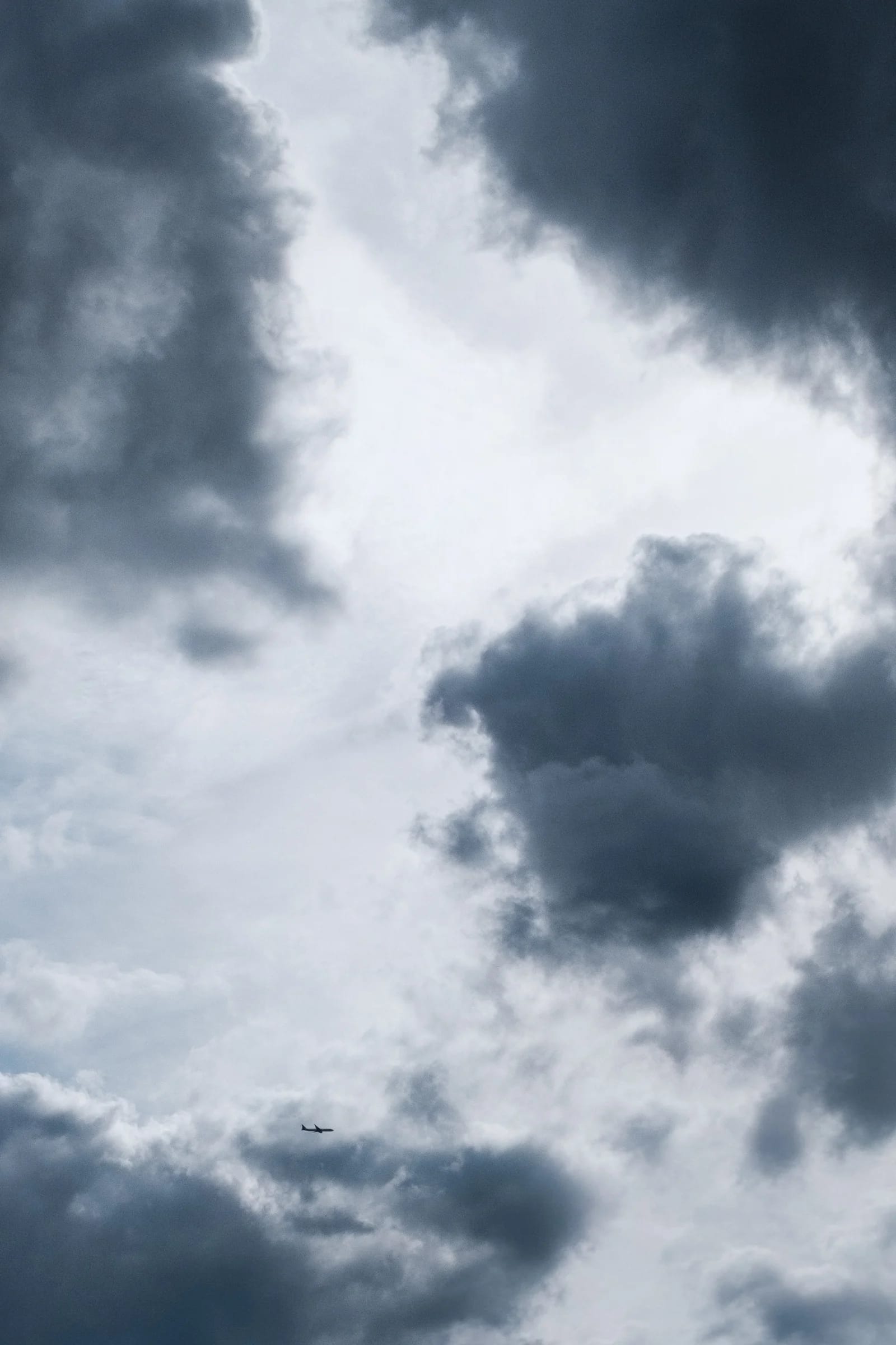 Airplane Flying Through Cloudy Sky