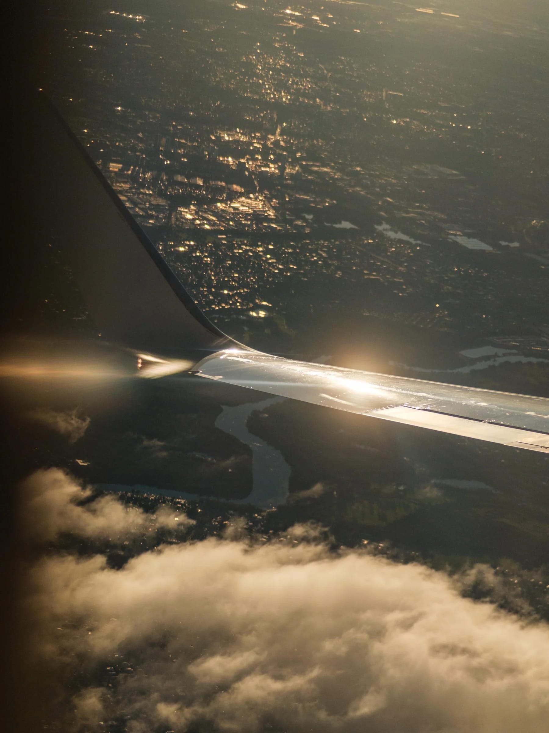 Airplane Wing Above Illuminated City