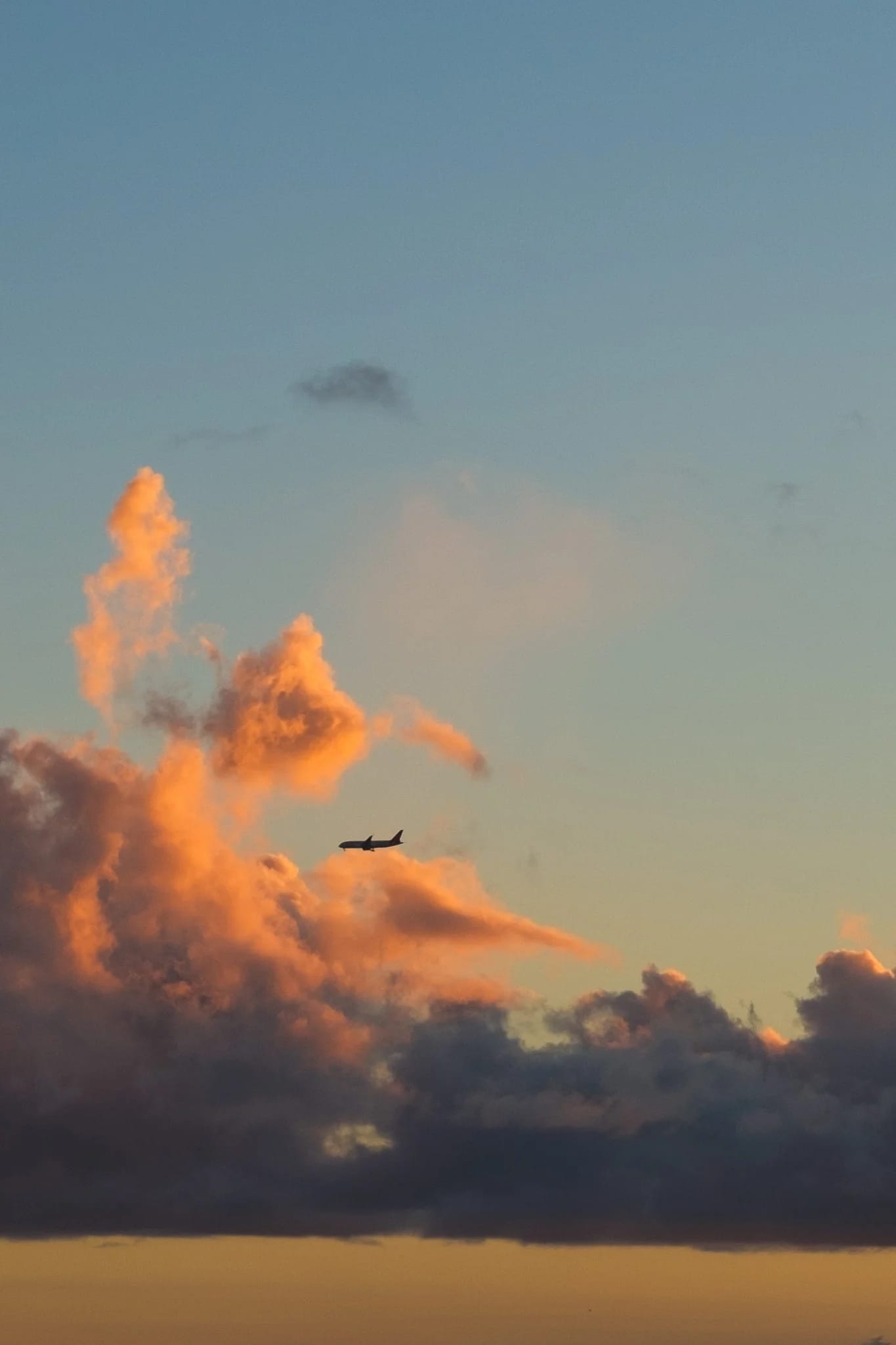 Airplane Amidst Sunset Clouds