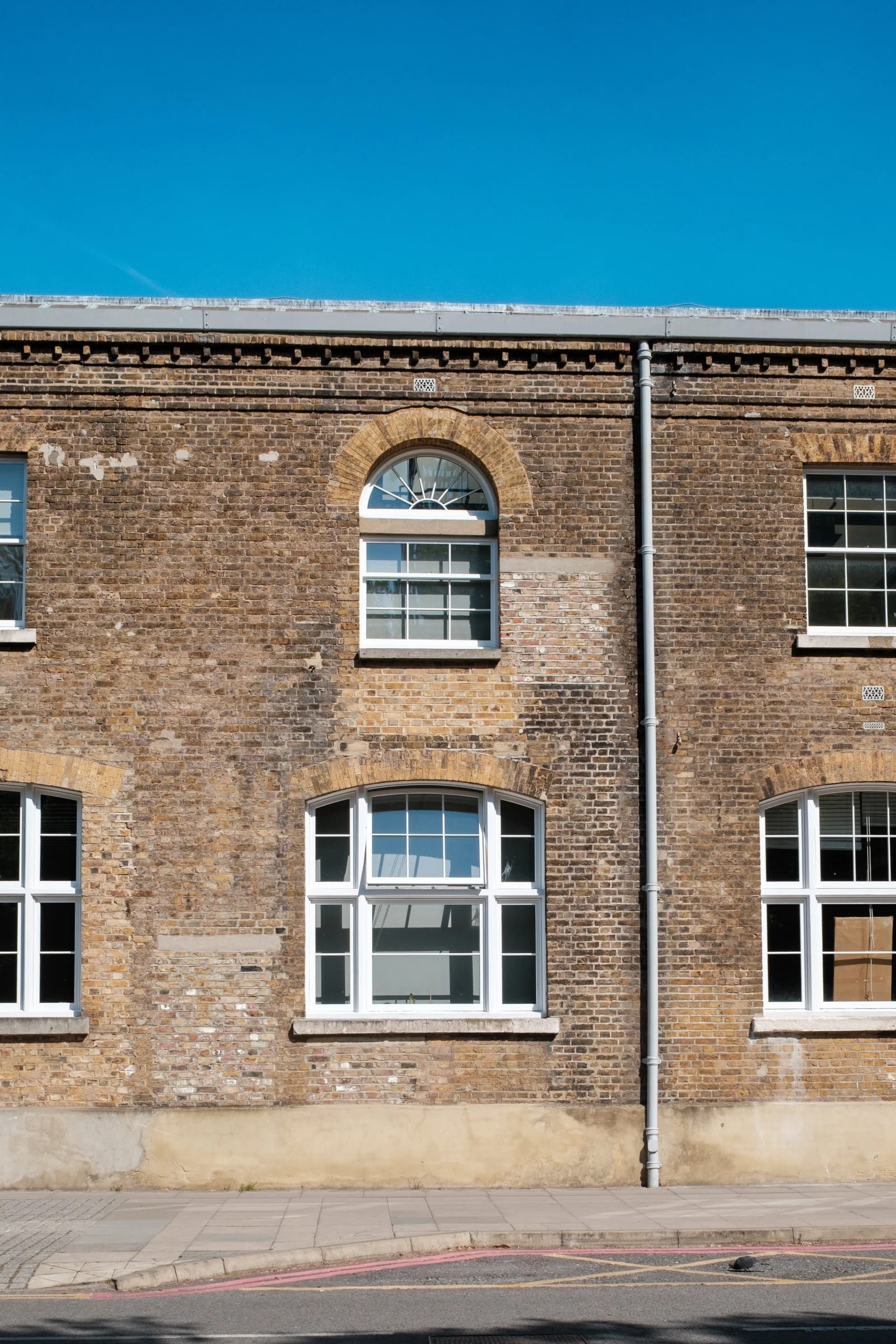 Historic Brick Building Under Blue Sky