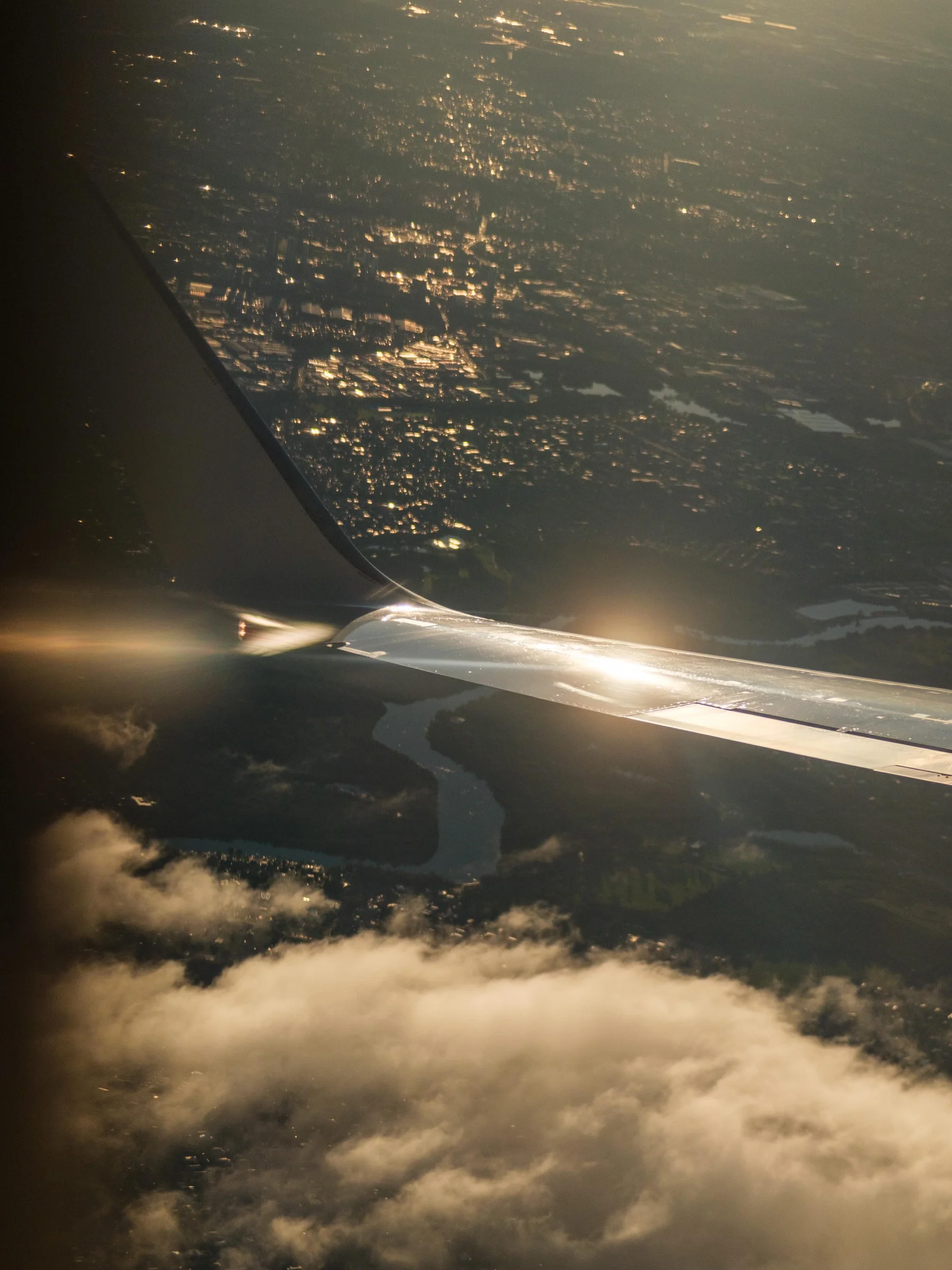 Airplane Wing Above Illuminated City