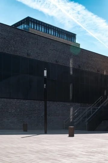 Dark brick building with glass roof